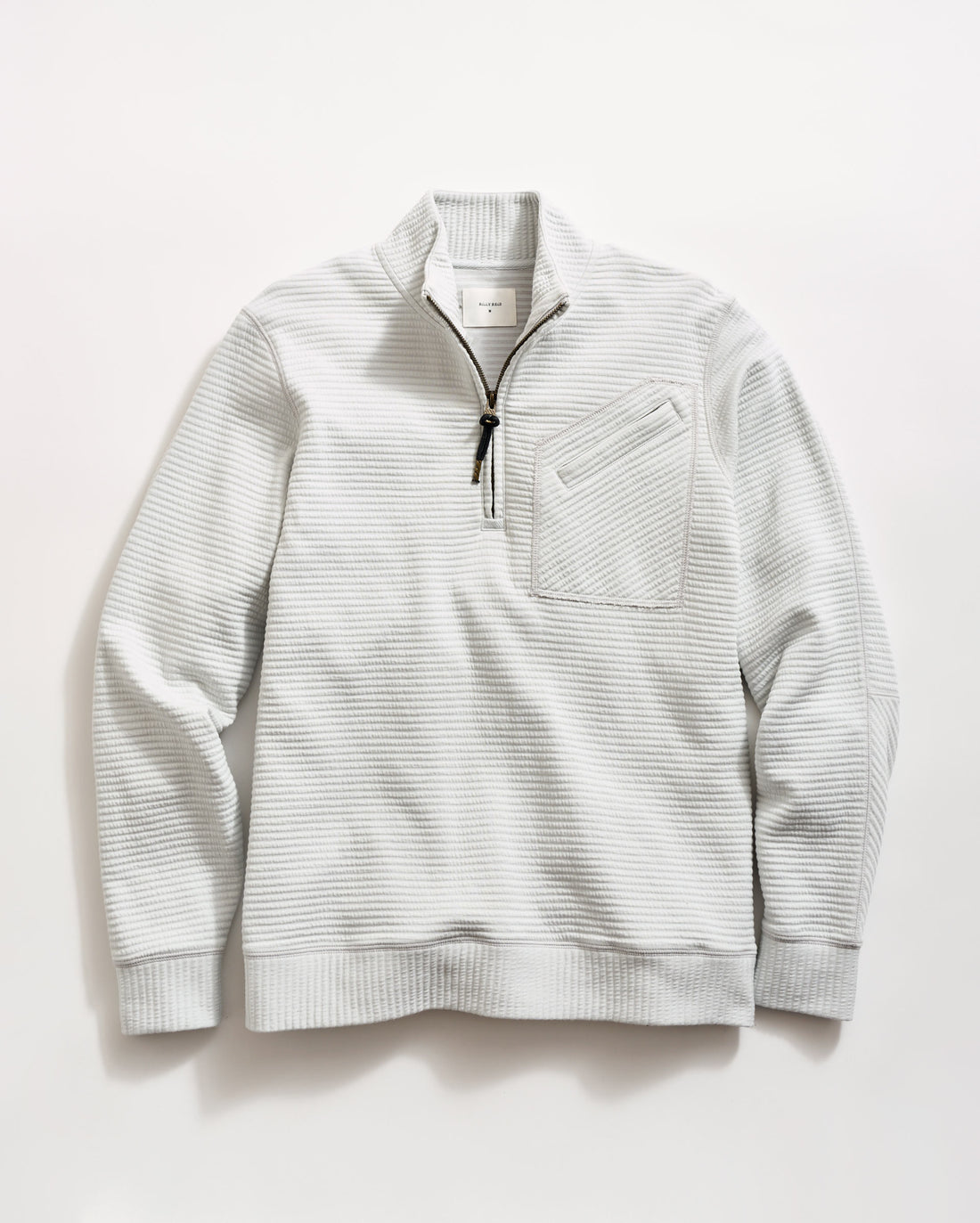 Light gray, long-sleeve pullover sweater with a quarter-zip front, black zipper pull, ribbed cuffs and hem, and a textured waffle pattern. A small chest pocket with a diagonal opening is on the left side.