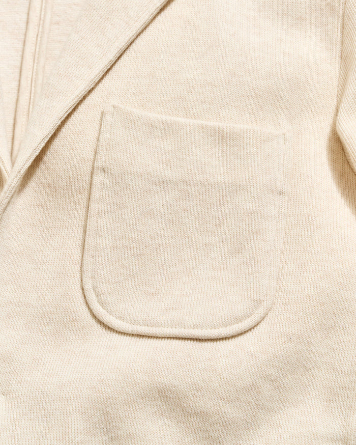 Close-up of a beige fabric with a pocket detail