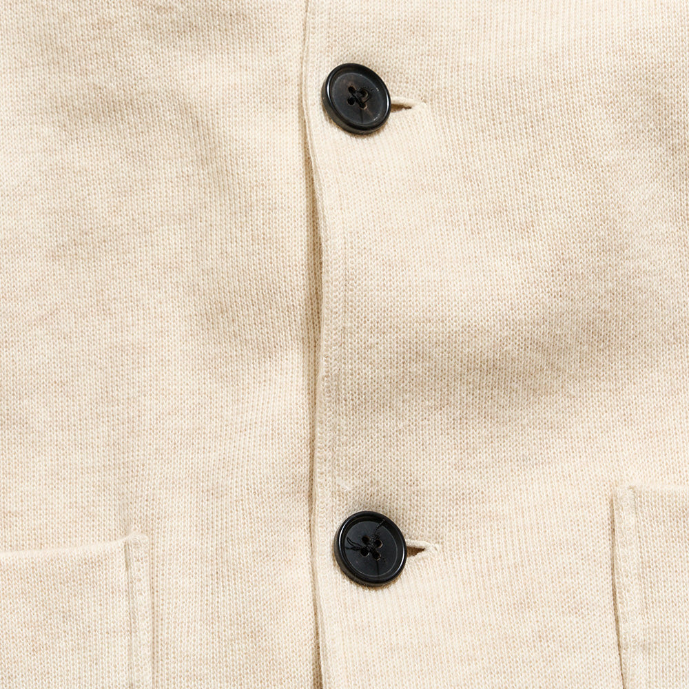 Close-up of a beige fabric with black buttons