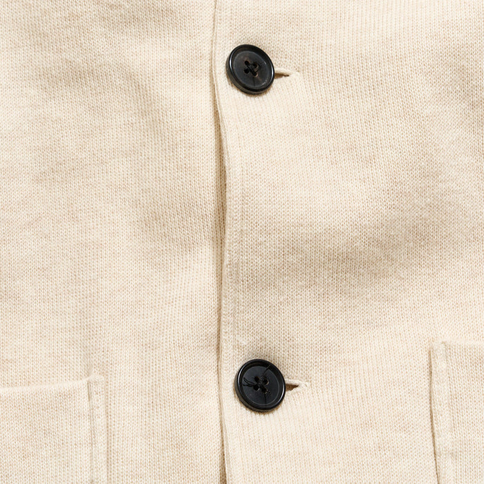 Close-up of a beige fabric with black buttons