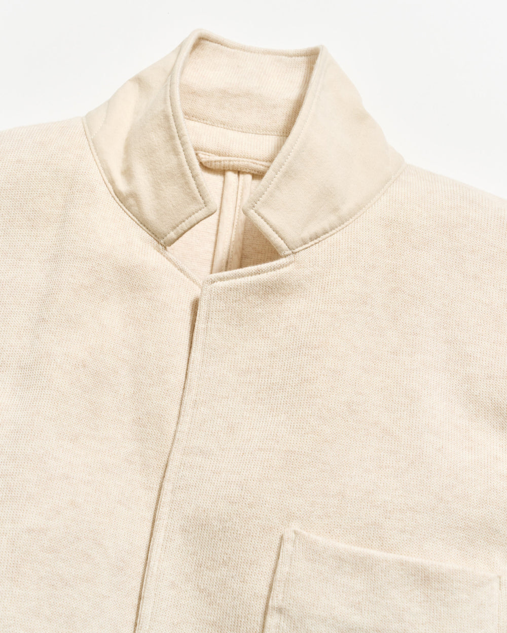 Close-up of a beige jacket with a collar on a light background