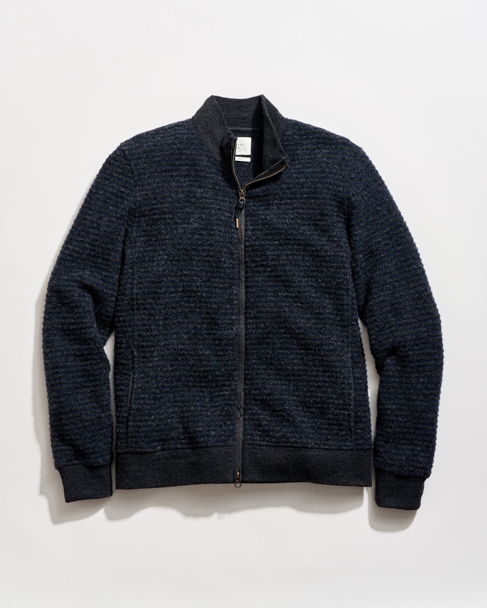 Dark blue zip-up sweater on a light gray background