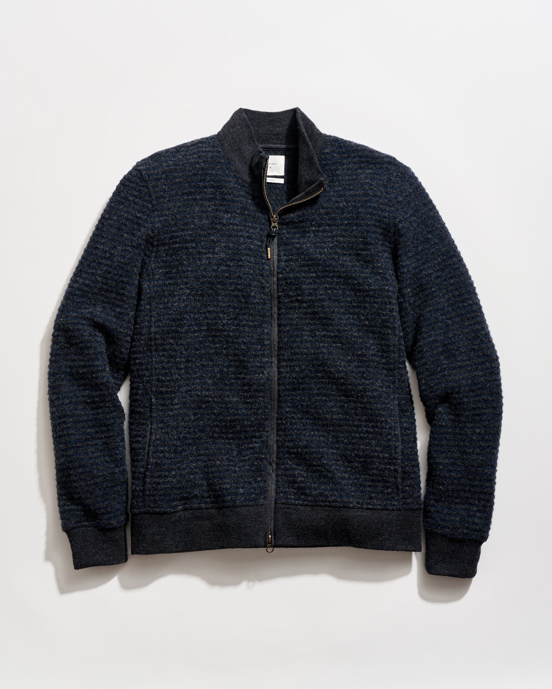Dark blue zip-up sweater on a light gray background