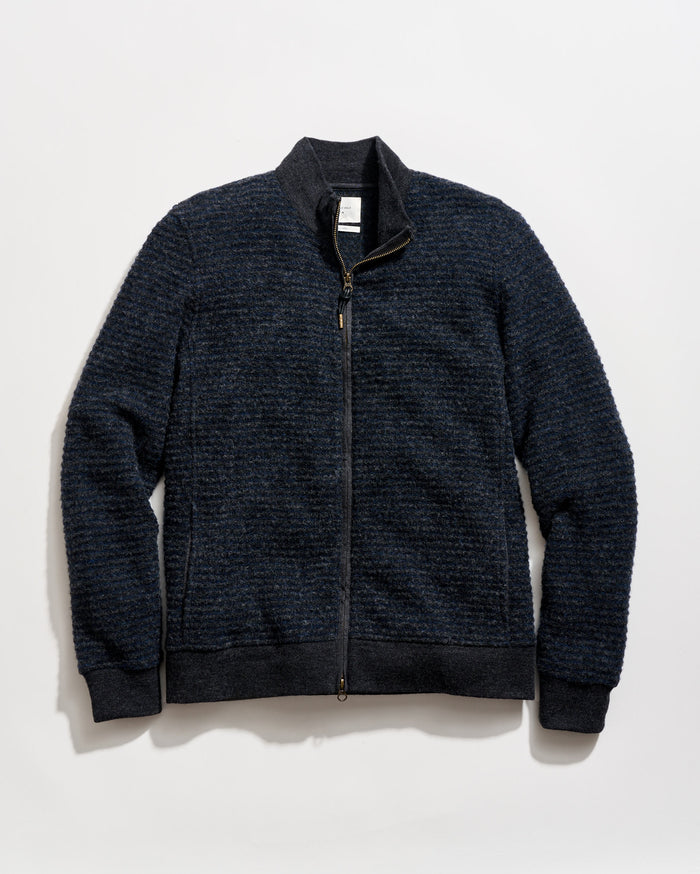 Dark blue zip-up sweater on a light gray background
