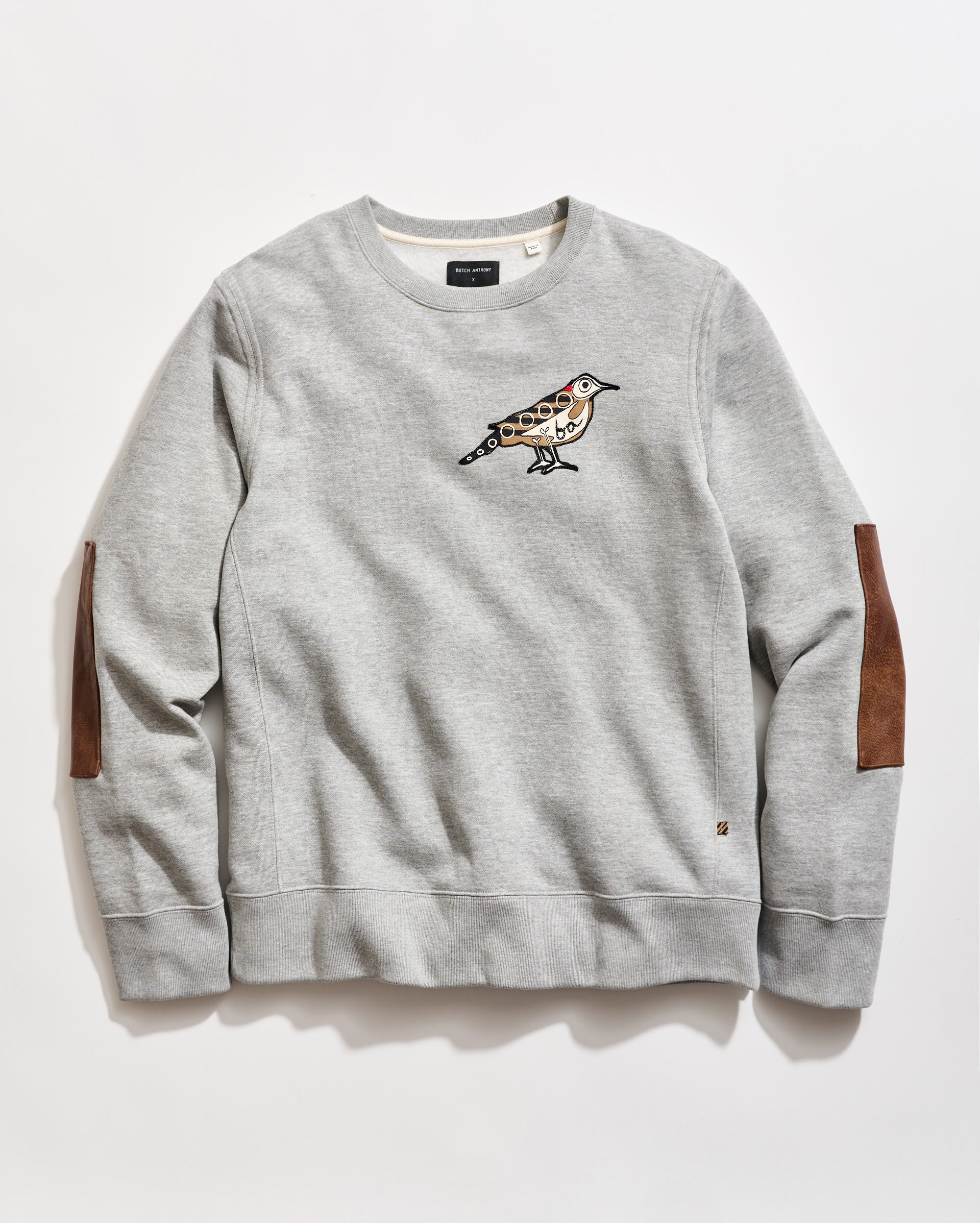 Dover Sweatshirt Collab with artist Butch Anthony. His custom yellowhammer art has been transformed into a chain stitched patch at the left chest.