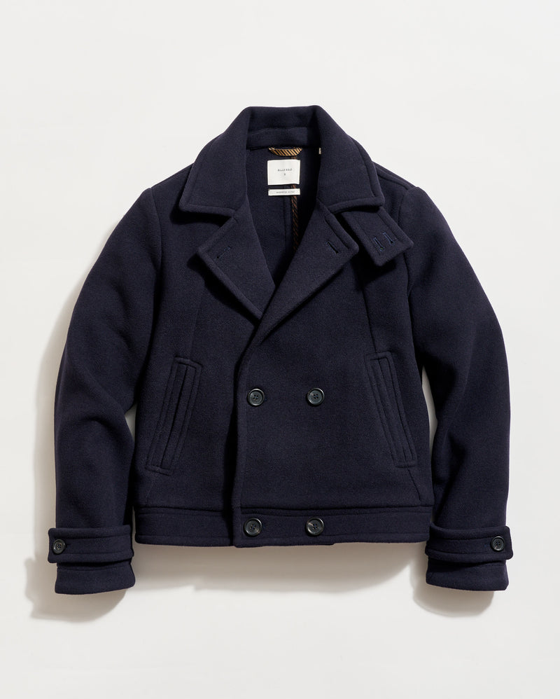 Navy peacoat on a light beige background