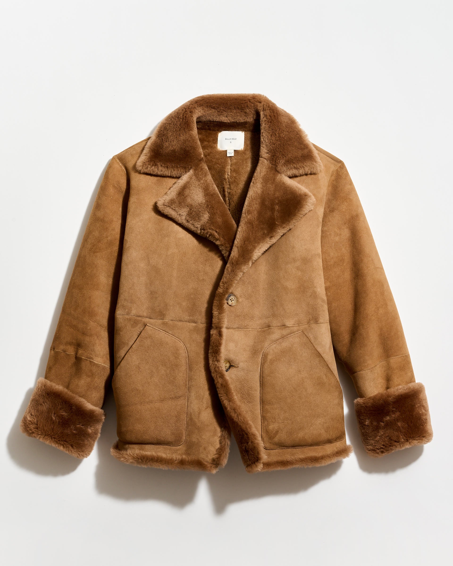 Brown shearling coat on a light gray background