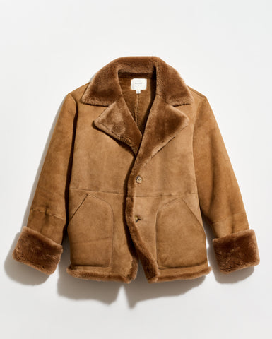 Brown shearling coat on a light gray background
