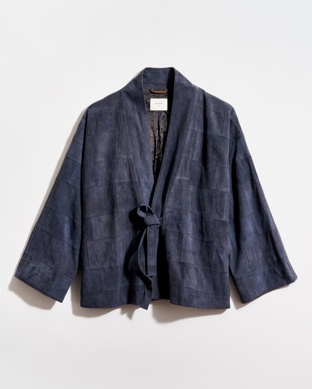 Navy blue checkered wrap coat on a light gray background