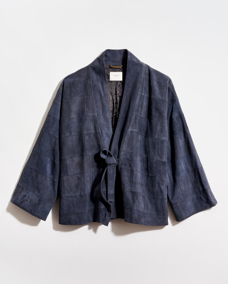 Navy blue checkered wrap coat on a light gray background