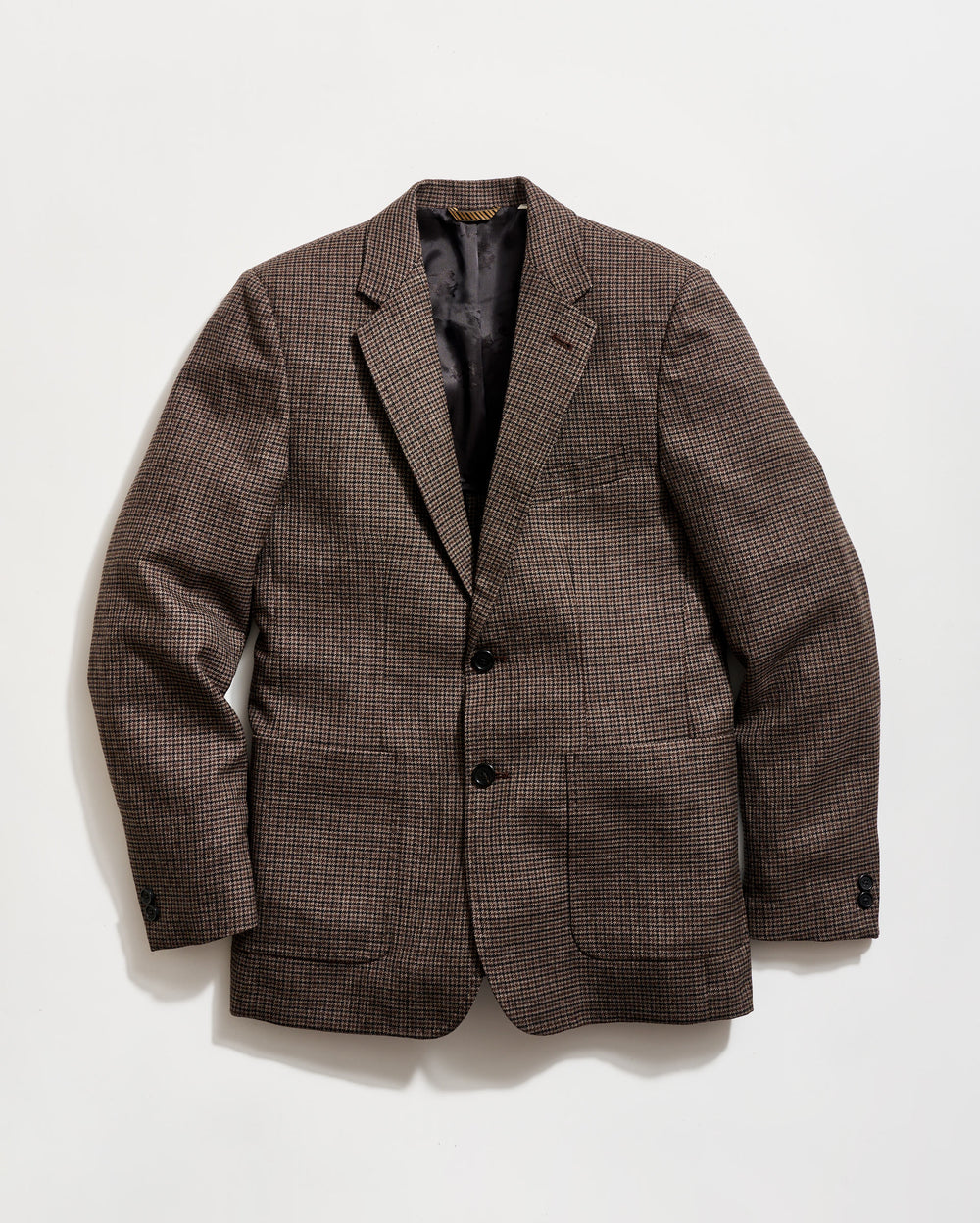 Brown checkered blazer on a light gray background