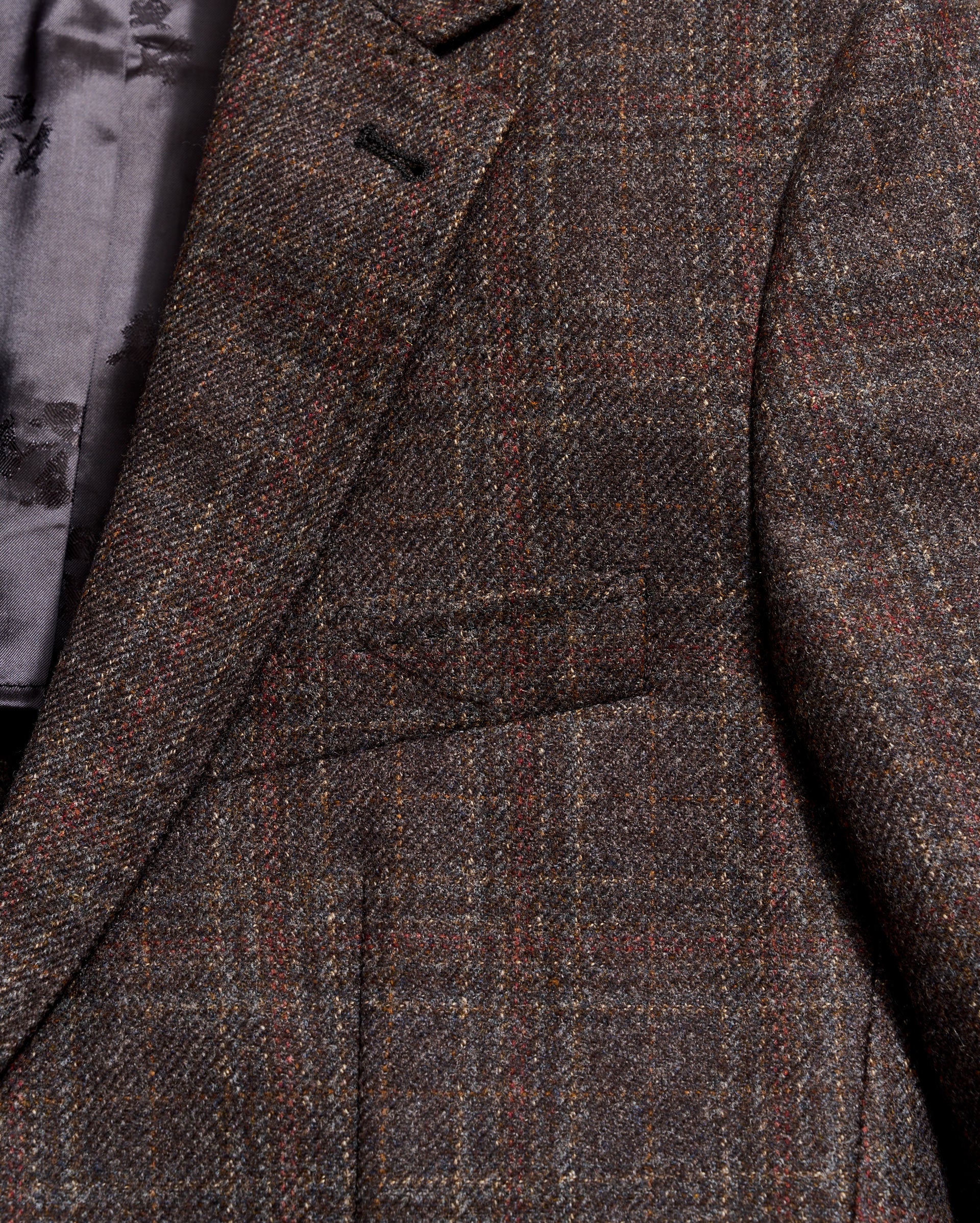 Close-up of a brown checkered coat with a focus on texture and pattern.