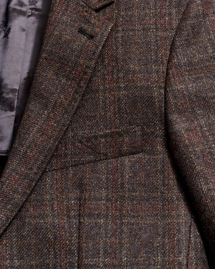 Close-up of a brown checkered coat with a focus on texture and pattern.