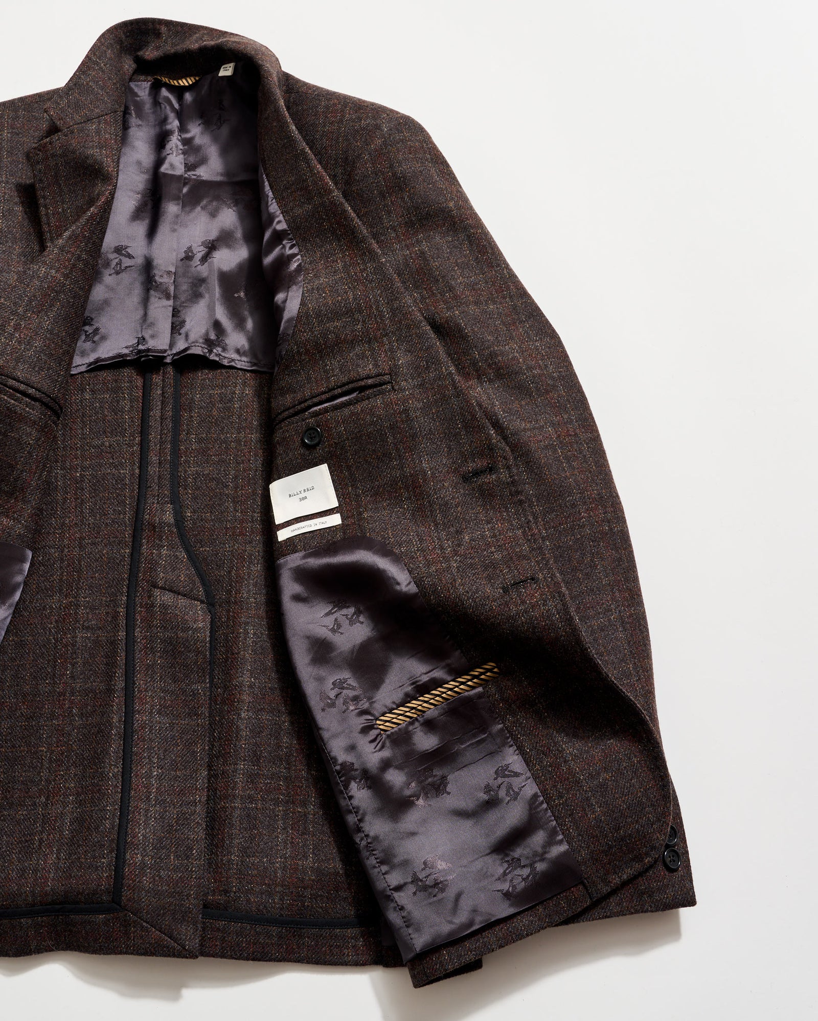 Brown checkered jacket with floral lining on a white background