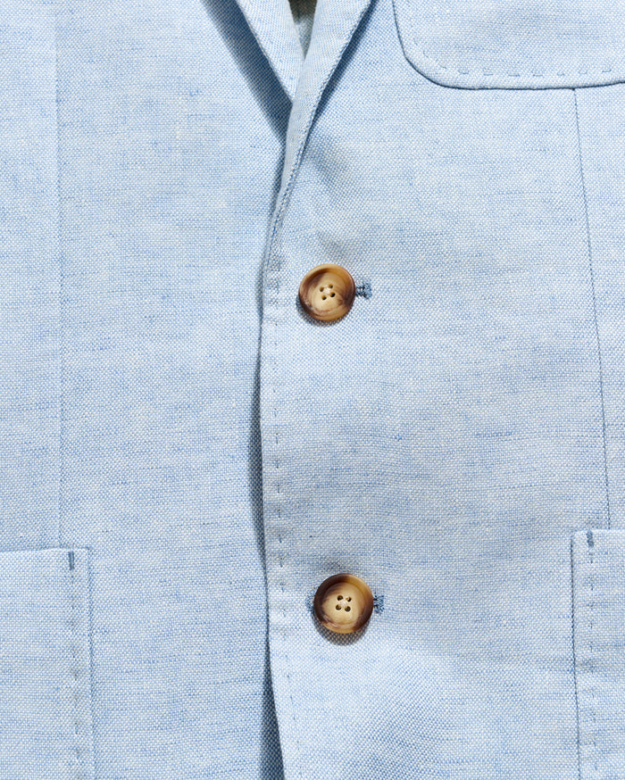 Close-up of a light blue shirt with wooden buttons