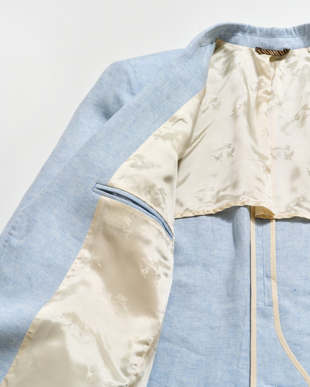 Light blue and beige fabric with a zipper on a light gray background