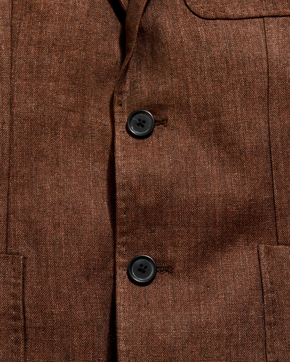 Close-up of a brown textured fabric with buttons