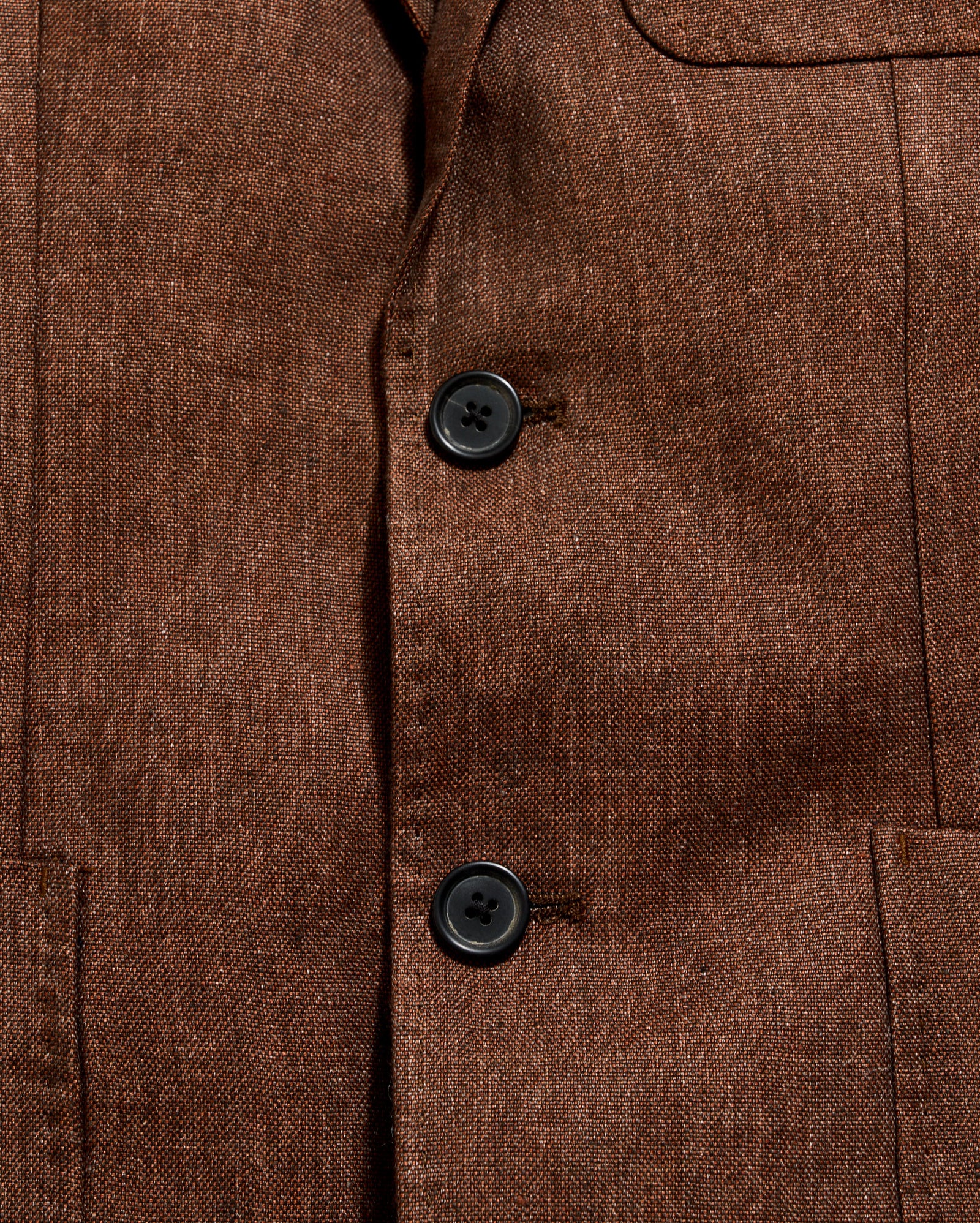 Close-up of a brown textured fabric with buttons