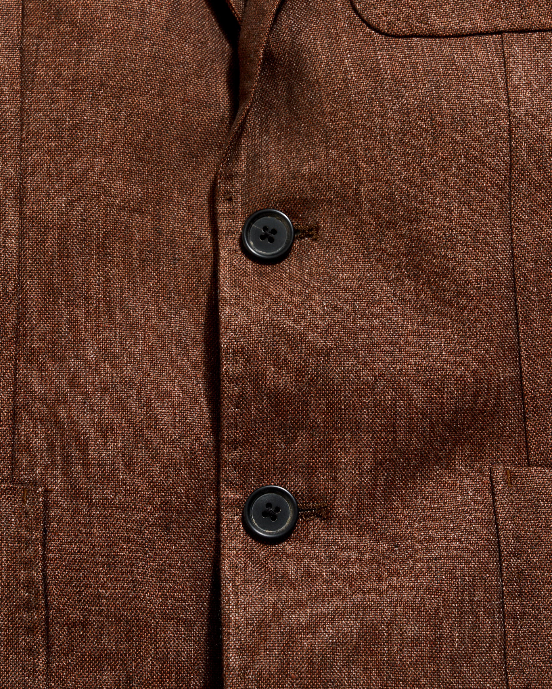 Close-up of a brown textured fabric with buttons