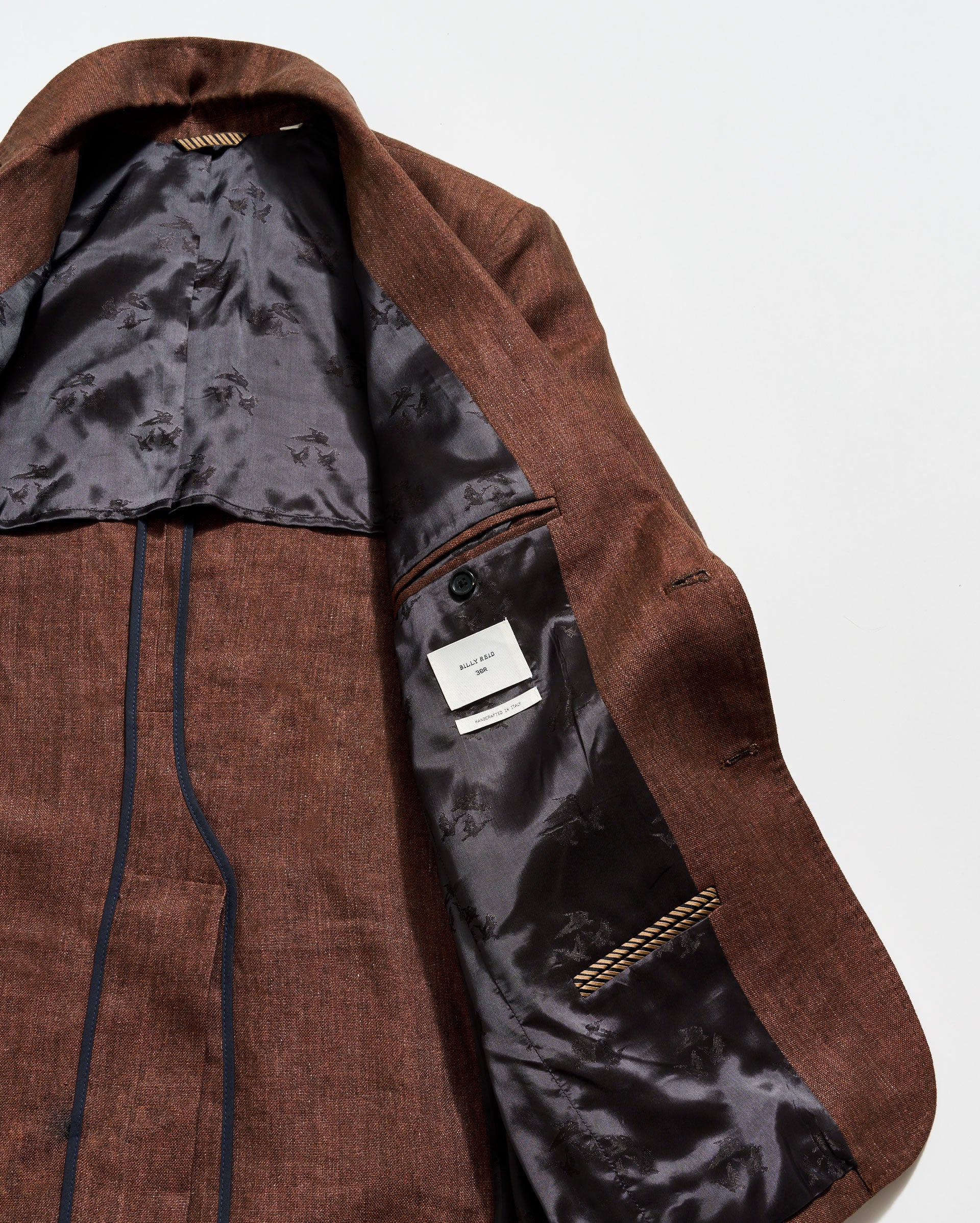 Brown coat with a visible brand label on a white background