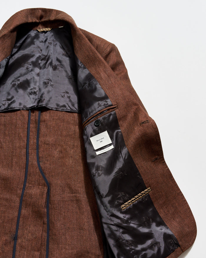 Brown coat with a visible brand label on a white background