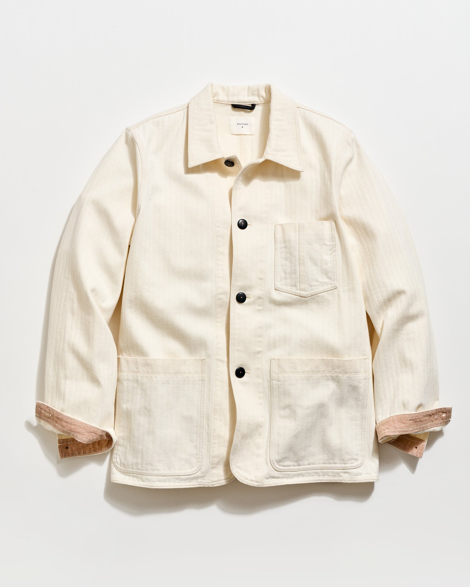 Beige jacket with button details on a white background