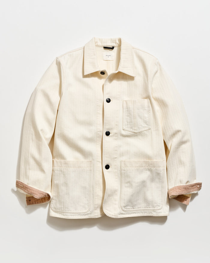 Beige jacket with button details on a white background