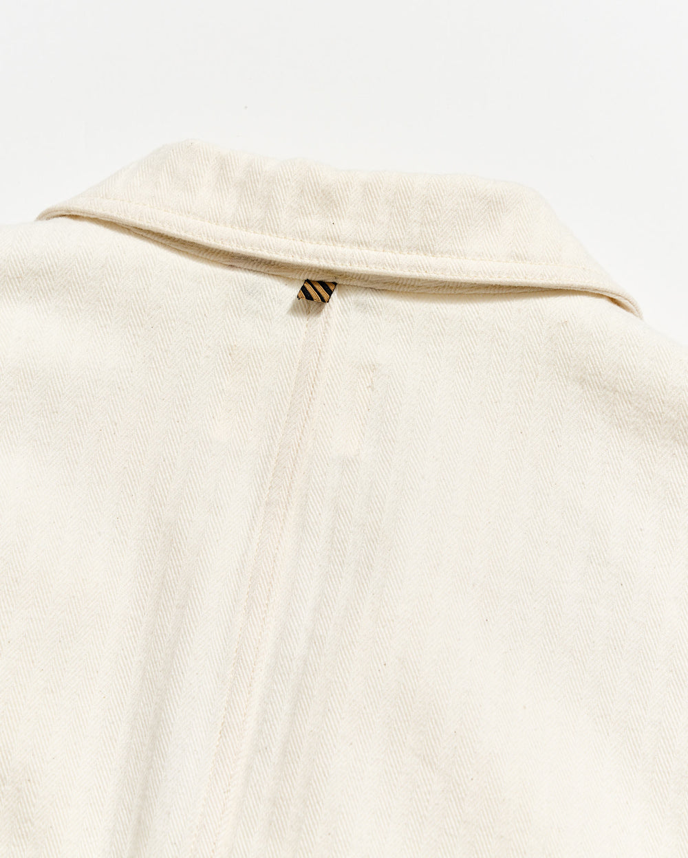 Close-up of a beige garment with a zipper on a white background