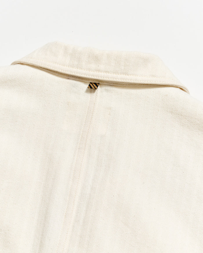 Close-up of a beige garment with a zipper on a white background