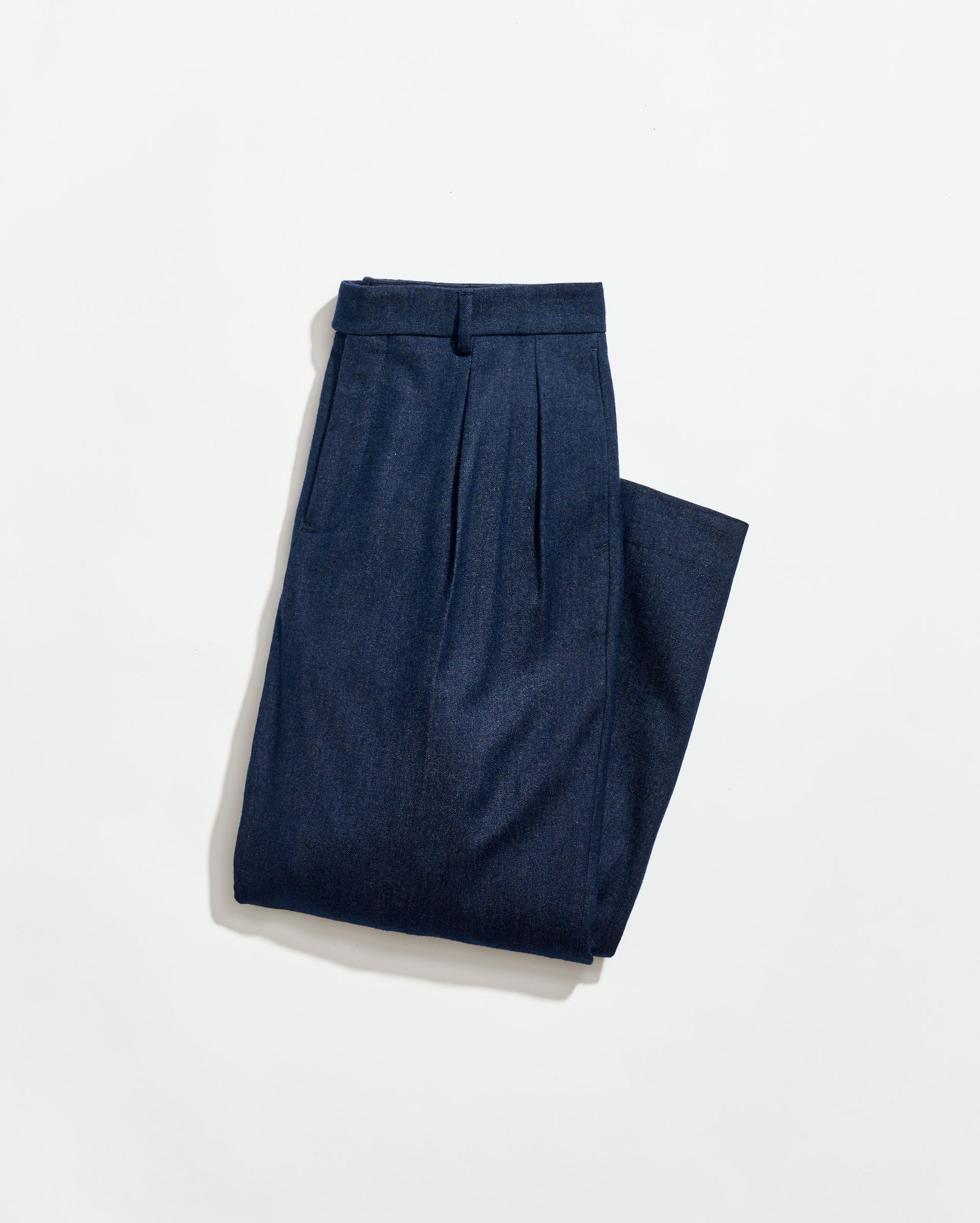 Pair of blue pleated pants on a white background
