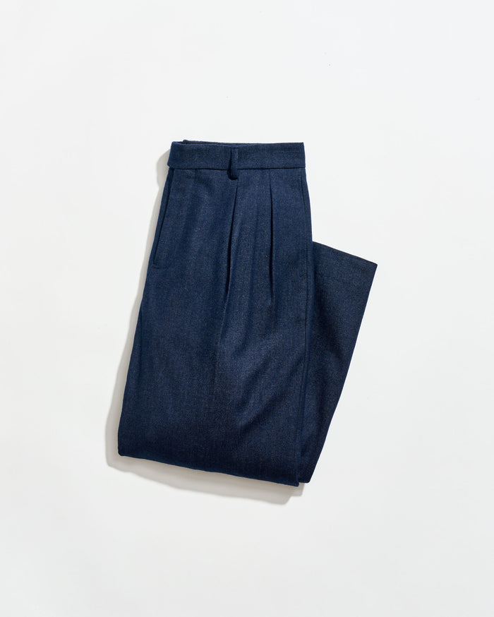 Pair of blue pleated pants on a white background