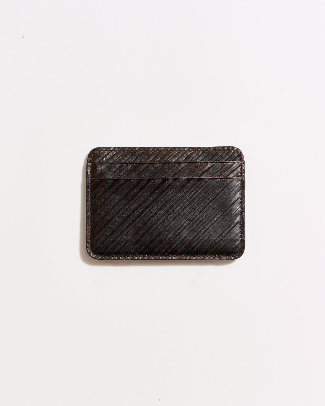 A dark brown leather cardholder with diagonal stitching, placed on a plain white background.