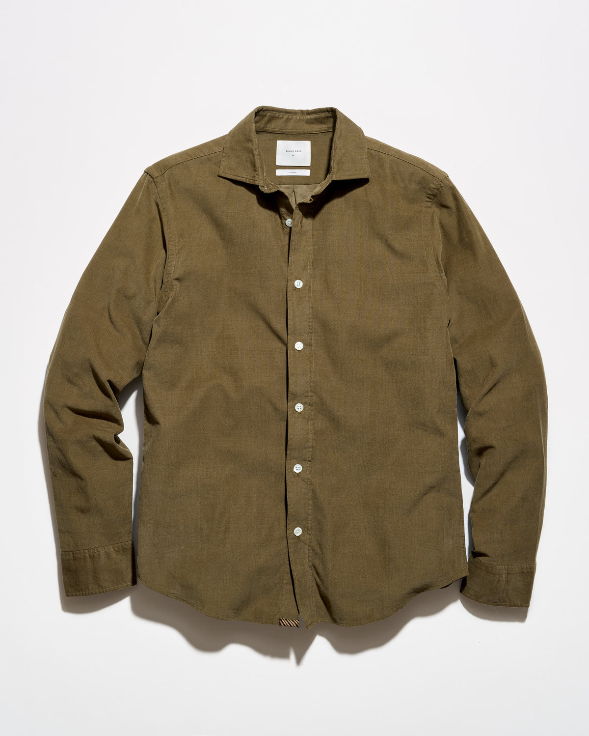 An olive green corduroy button-down shirt with white buttons, laid flat against a white background.