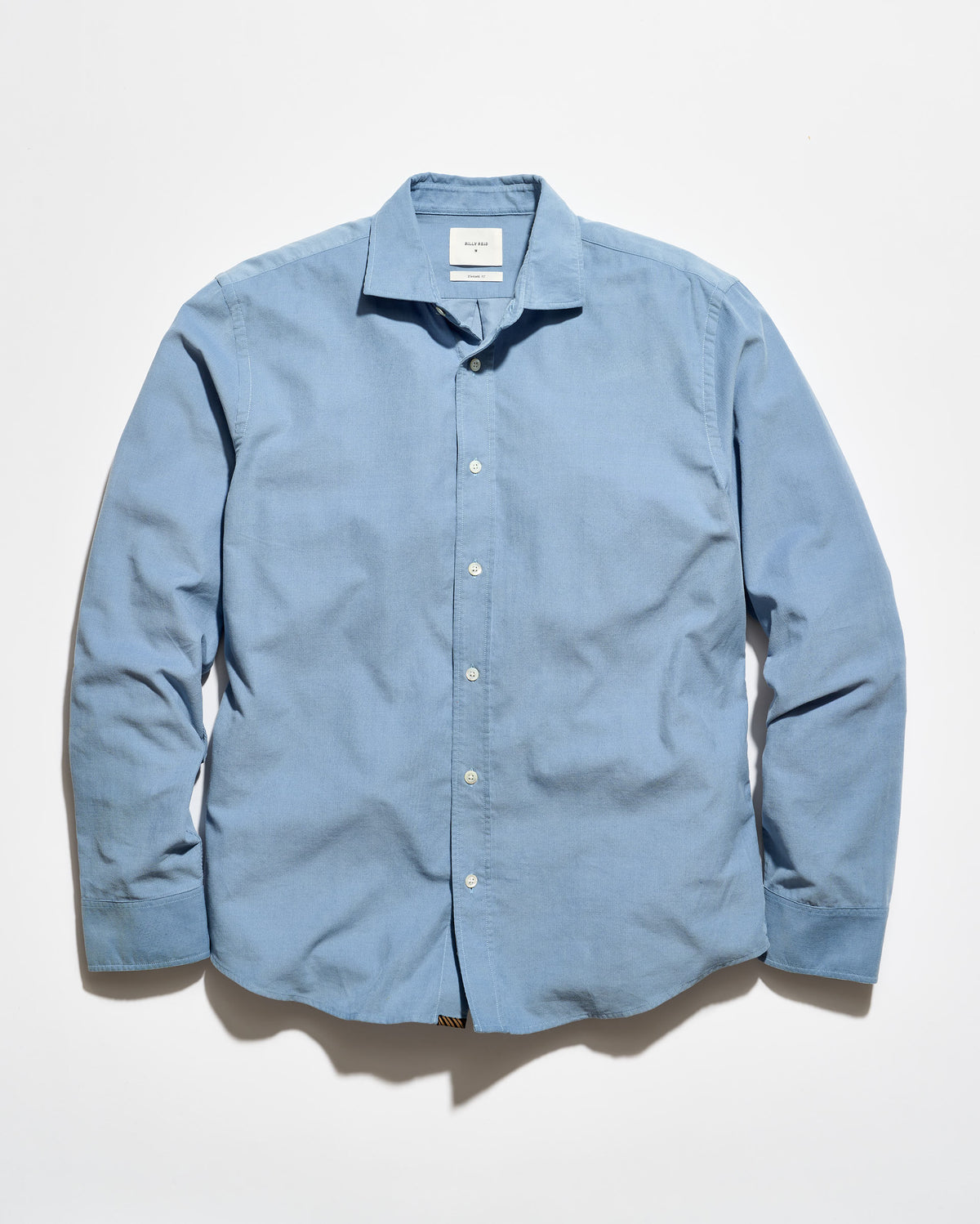 A light blue long-sleeve button-up shirt with a pointed collar, laid flat against a white background.