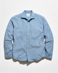 A light blue long-sleeve button-up shirt with a pointed collar, laid flat against a white background.