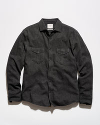 A dark charcoal gray textured long-sleeve button-up shirt with two buttoned chest pockets, laid flat against a light gray background.