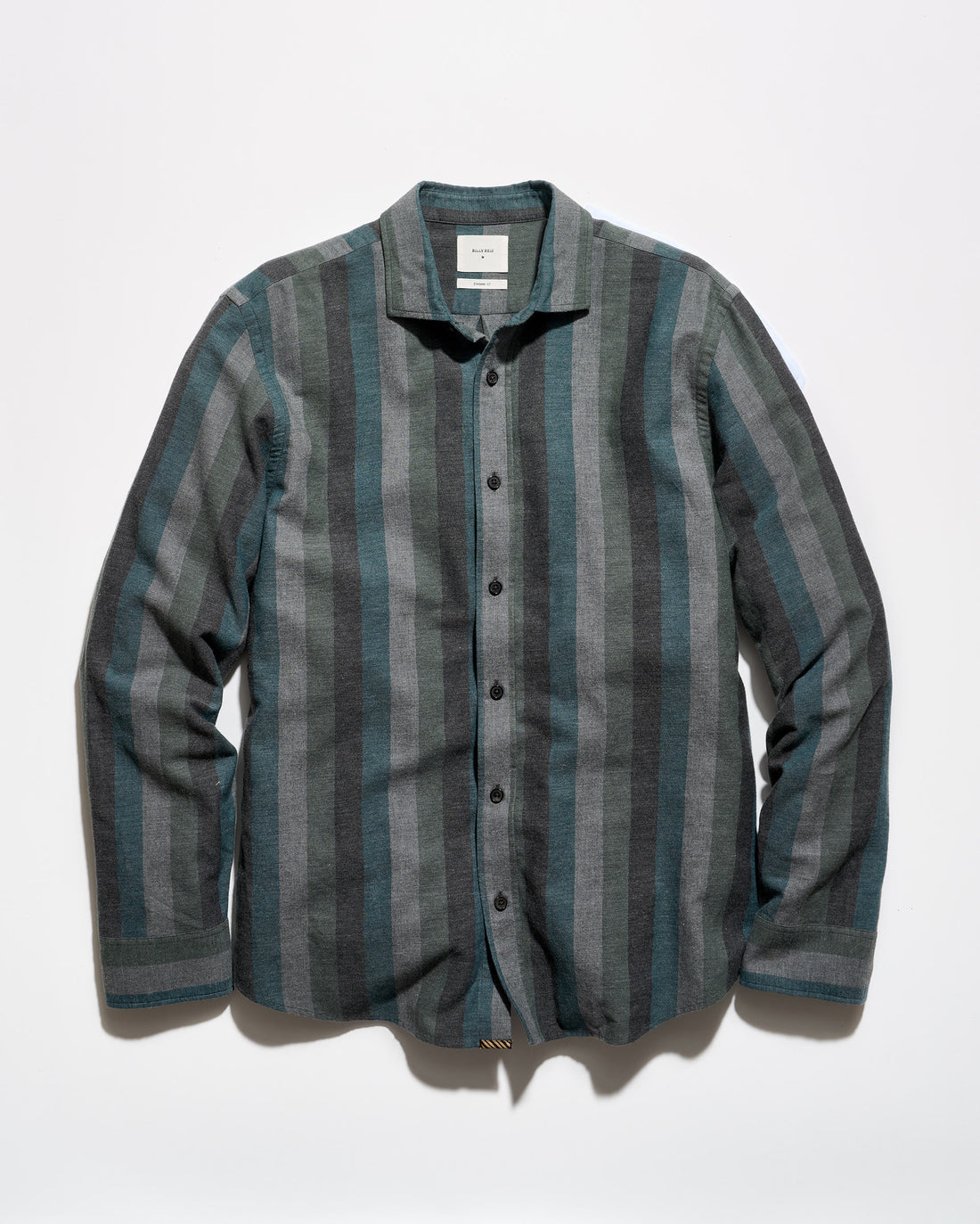 A long-sleeve button-up shirt with vertical stripes in slate blue, gray, and charcoal, laid flat against a white background.