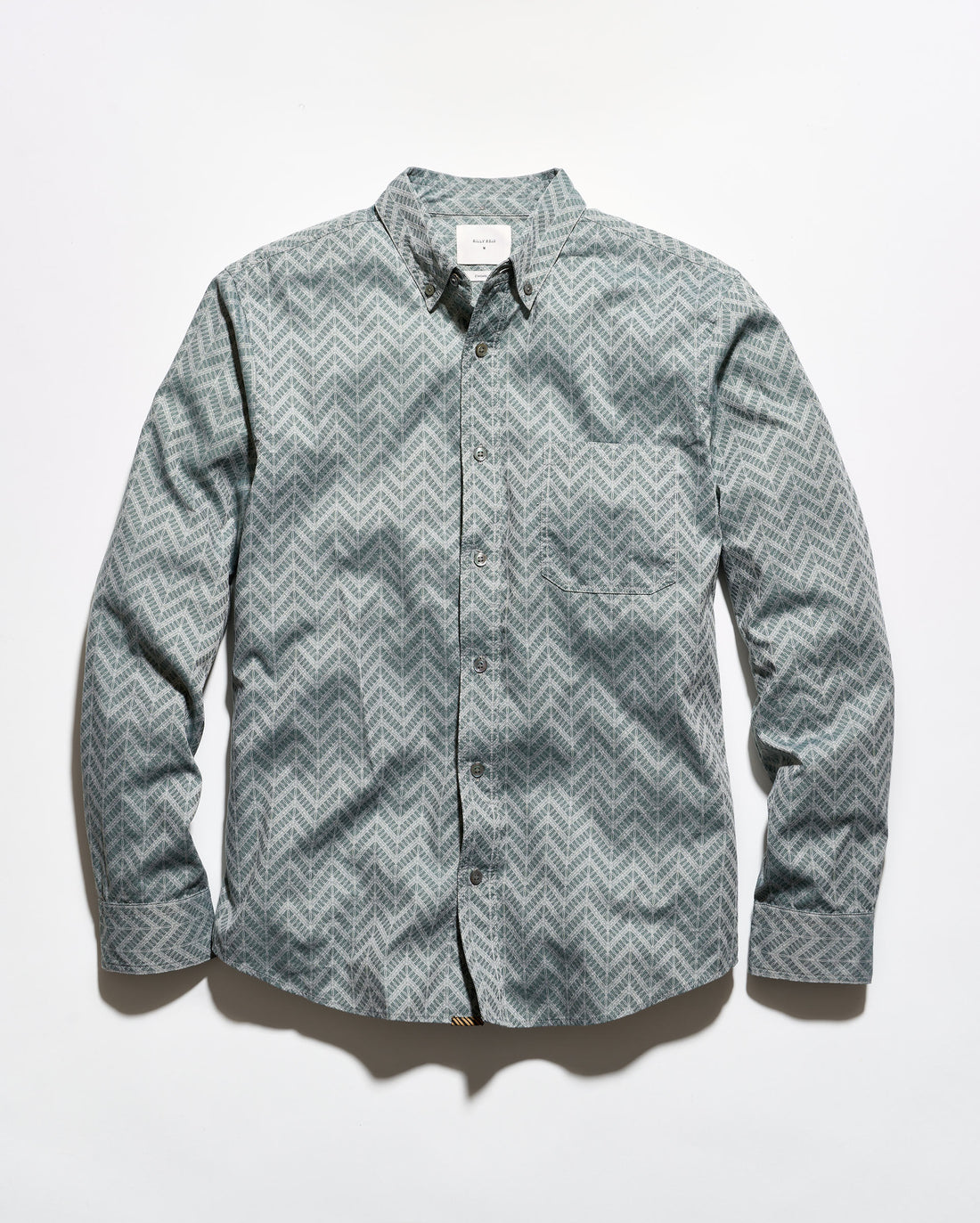 A long-sleeve button-up shirt with a gray and white chevron pattern, laid flat against a white background.