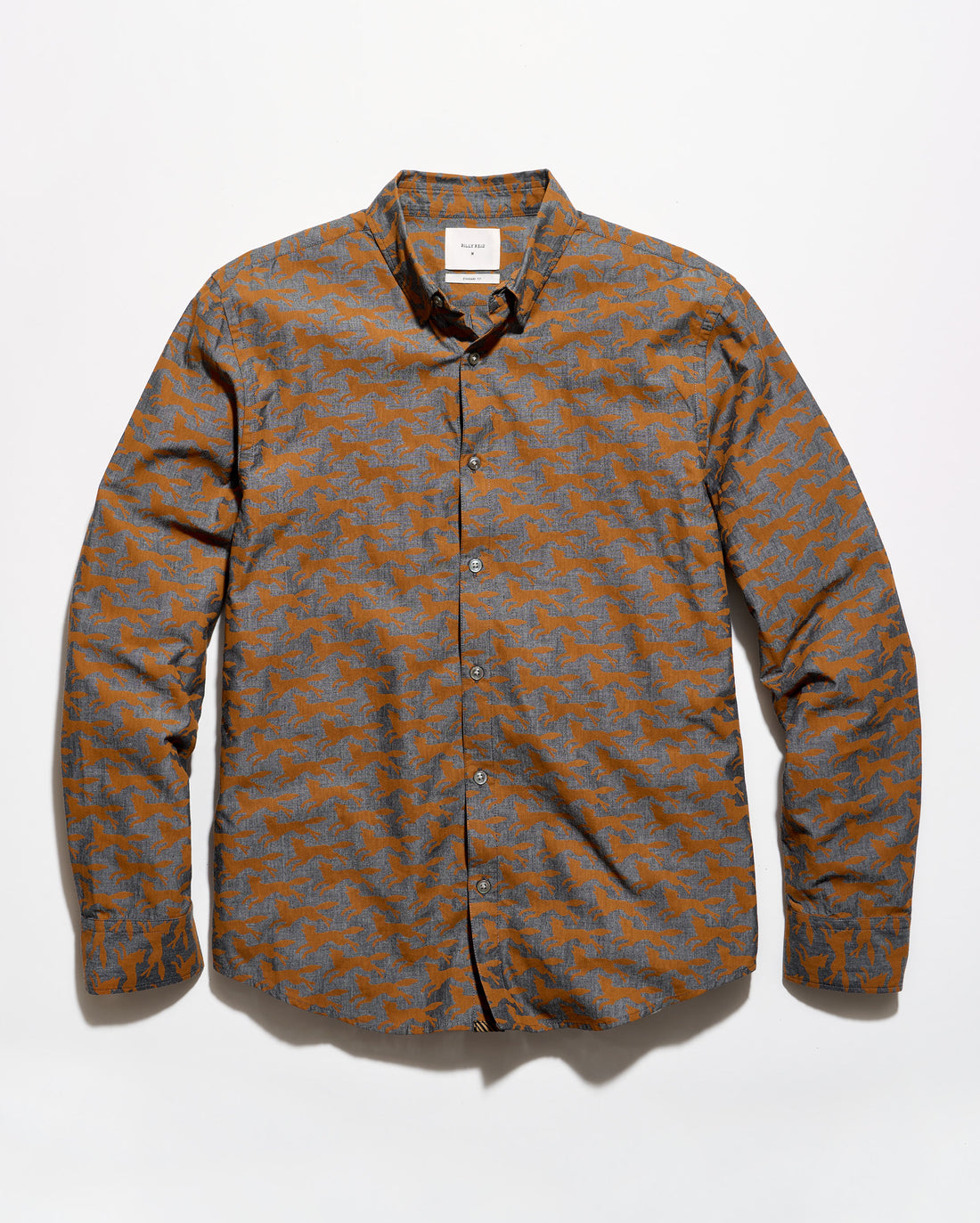 A long-sleeve button-up shirt with an abstract geometric pattern in orange and gray, laid flat against a white background.
