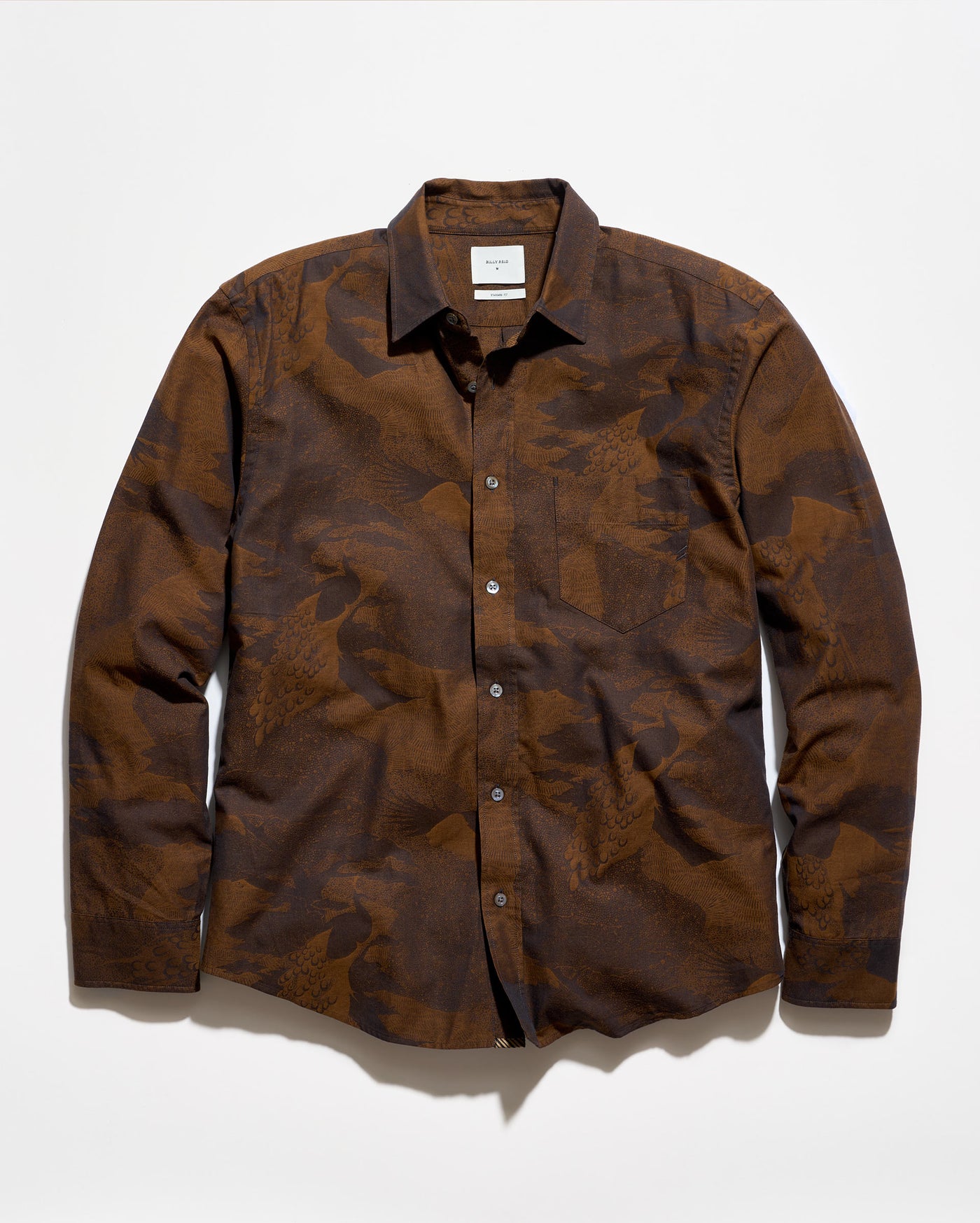 A long-sleeve button-up shirt with a brown and dark brown abstract camouflage pattern, laid flat against a white background.
