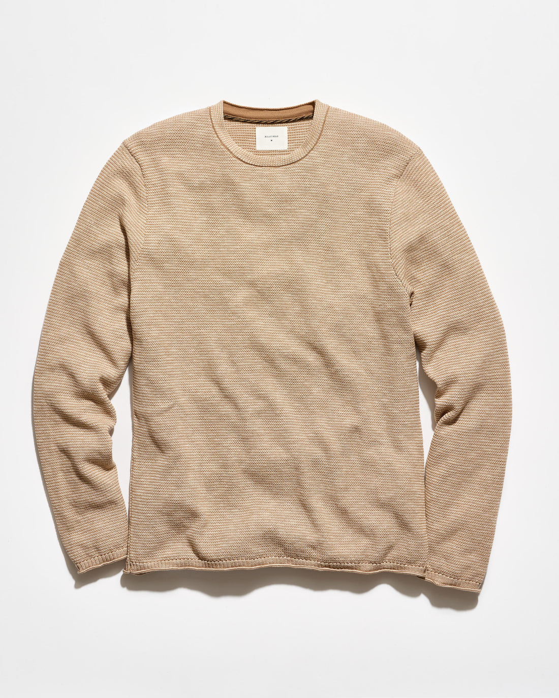 A beige ribbed long-sleeve crewneck sweater laid flat against a clean white background.