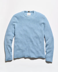 A light blue textured knit crewneck sweater with long sleeves, laid flat against a clean white background.