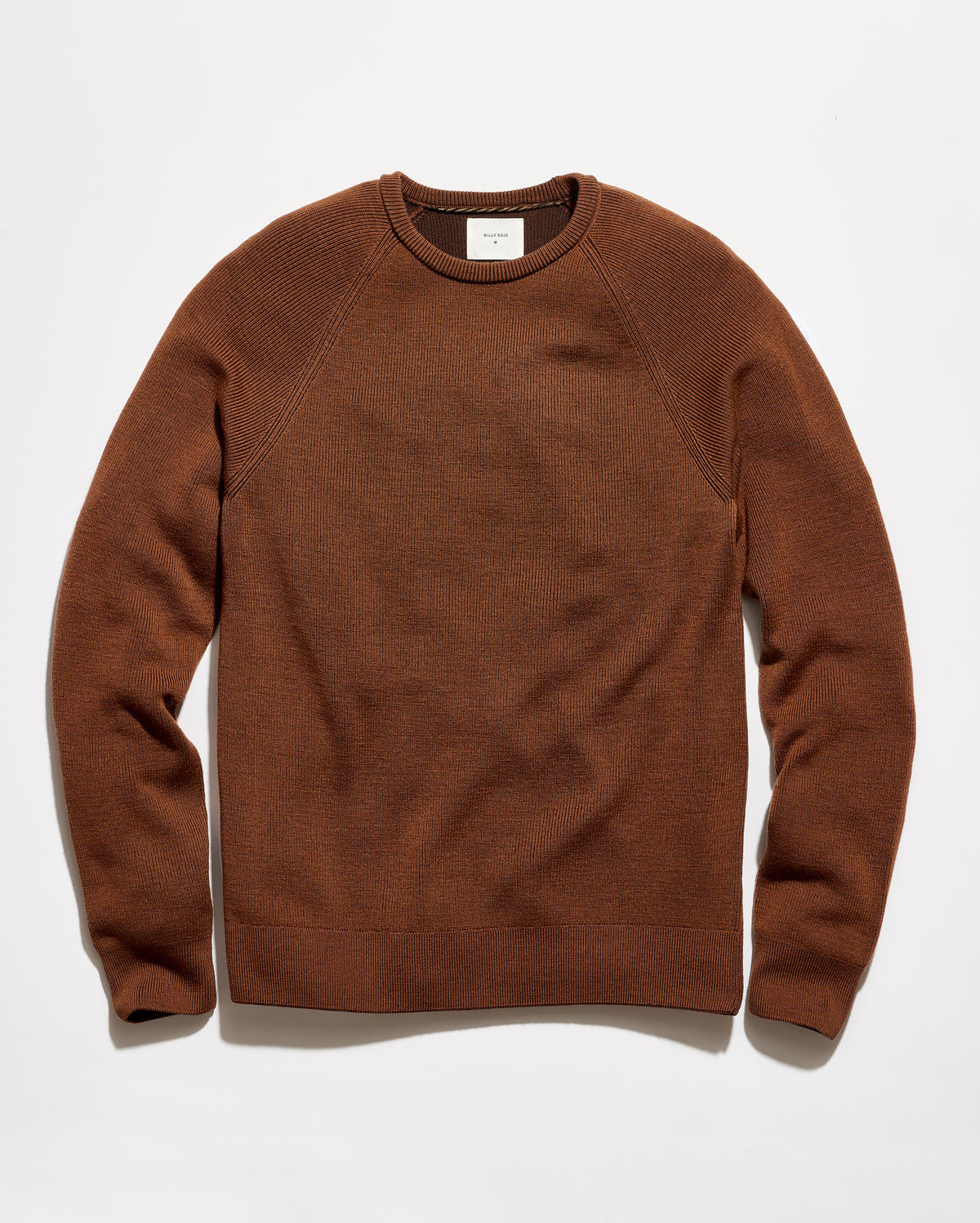 A brown crewneck knit sweater with raglan sleeves, laid flat against a clean white background.