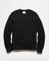A black long-sleeve crewneck sweater with a subtle speckled texture, laid flat against a clean white background.