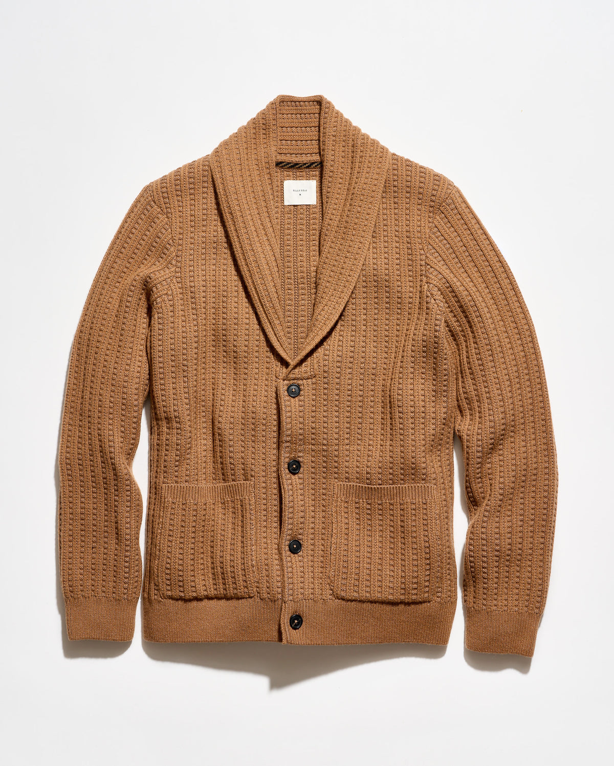 A camel brown ribbed knit cardigan sweater with a shawl collar, button closure, and front patch pockets, laid flat against a white background.