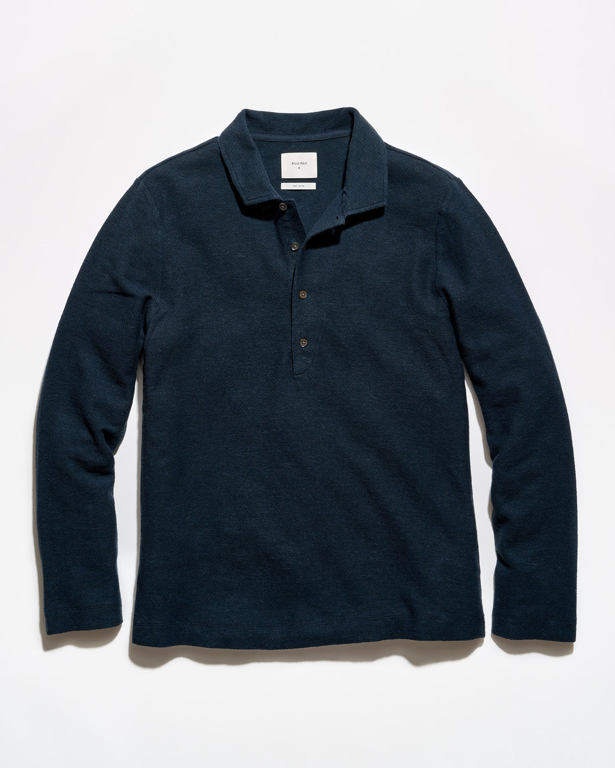 A dark navy blue long-sleeve polo shirt with a three-button placket, laid flat against a clean white background.