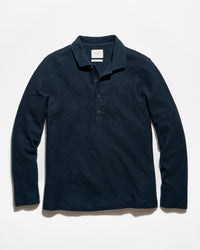A dark navy blue long-sleeve polo shirt with a three-button placket, laid flat against a clean white background.