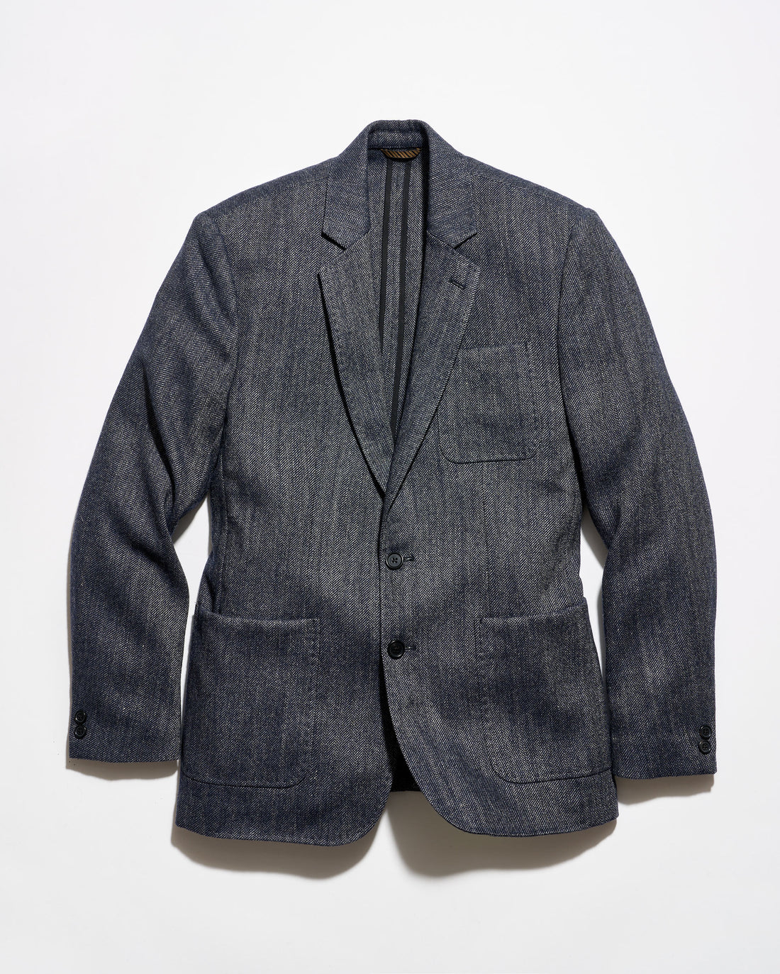 A dark gray textured wool-blend blazer with a subtle heathered pattern, featuring notch lapels, a two-button front closure, and flap pockets, displayed against a clean white background.