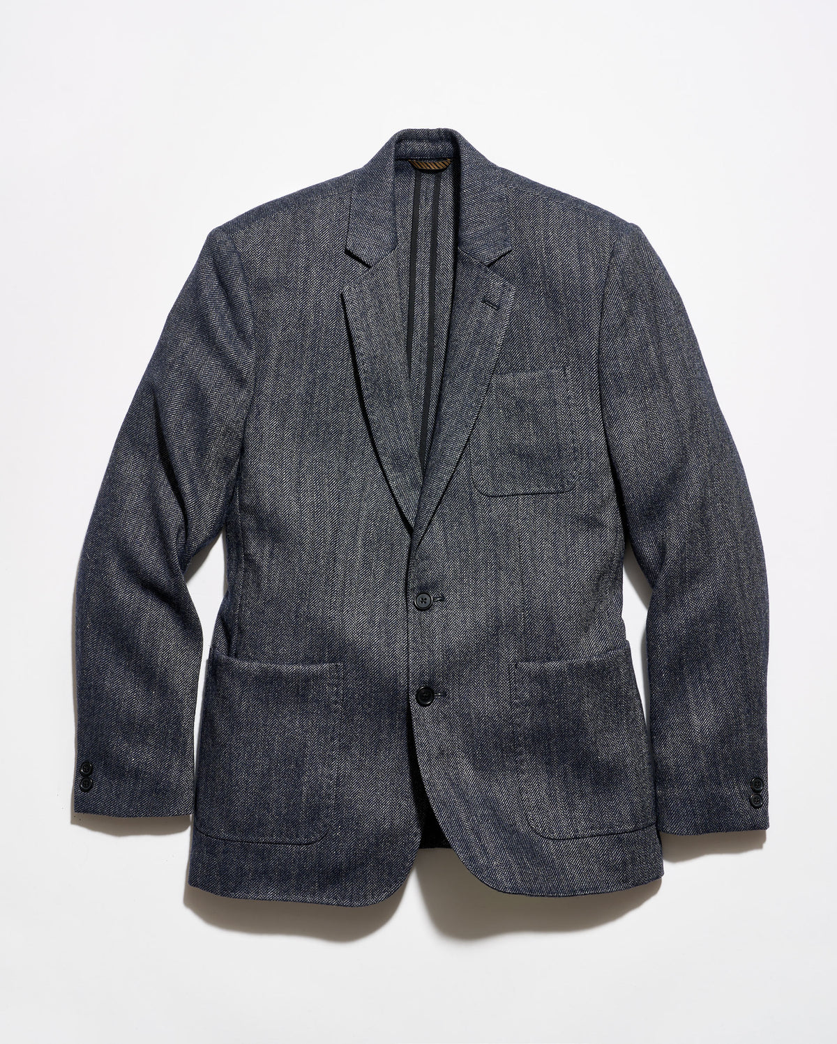A dark gray textured wool-blend blazer with a subtle heathered pattern, featuring notch lapels, a two-button front closure, and flap pockets, displayed against a clean white background.