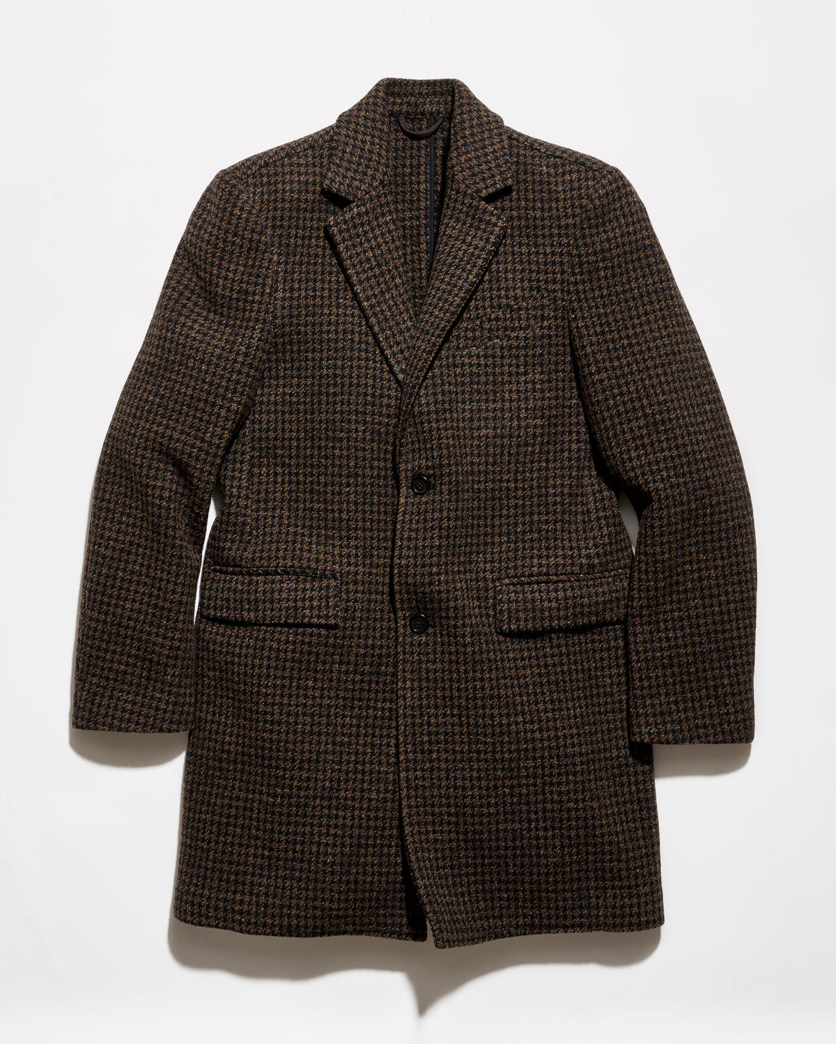 A dark brown and black houndstooth patterned blazer jacket, displayed flat against a plain white background.